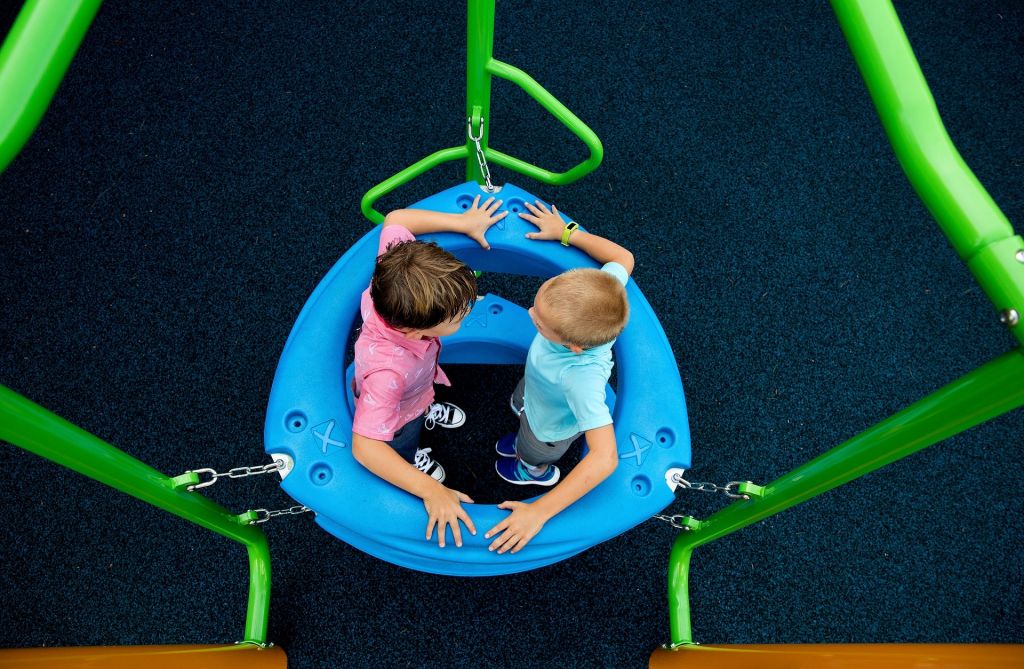 Kids playing on playground image 183d17ce614a305ef7e14498bef98c4b
