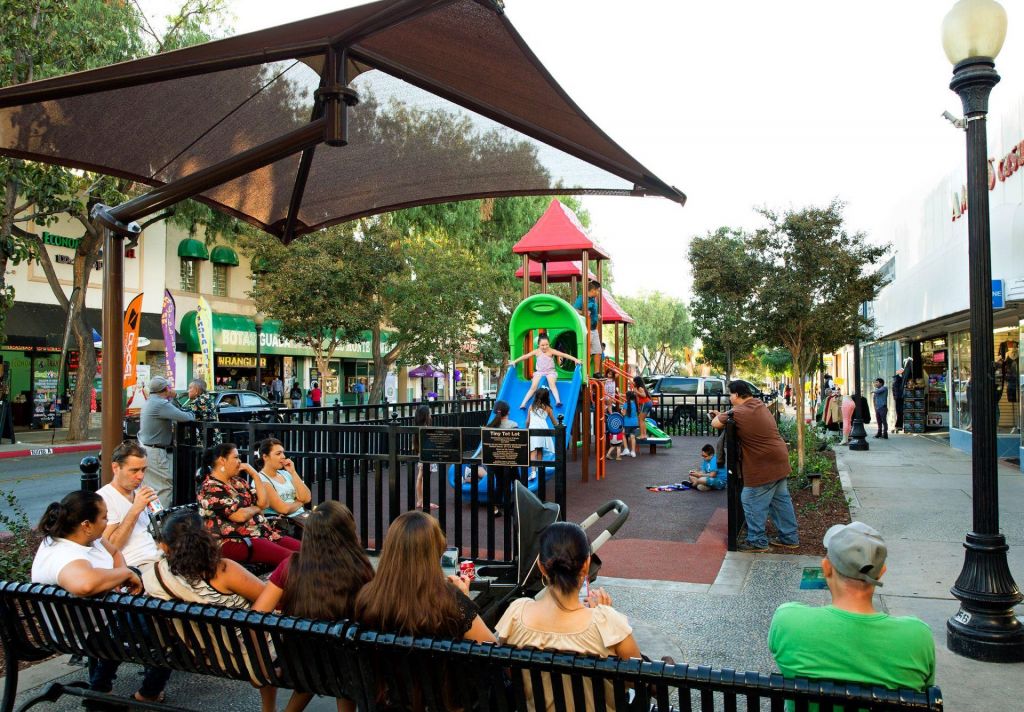 Playground in city benches with people and kids playing 183d17ce614a305ef7e14498bef98c4b 3